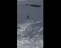 man in black skis down mountain failed back flip