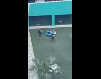 Woman lifts large tire with two men videographer