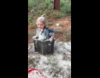 Kid acting like cat playing with  diatomaceous earth on box 