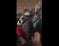 Girl throws half donut into crowd of people at school