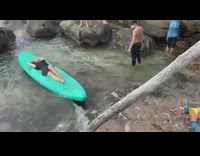 Woman black dress lie down green surfboard