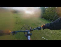 Filmer ride bike cleans camera small river 