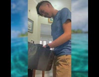 Blue shirt guy plays steel drum instrument 