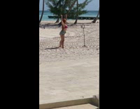 Woman red hair denim shorts dance beach