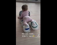 Baby lays on cleaning supplies 