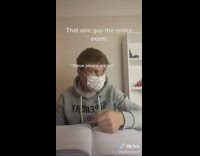 Guy grey sweater writing notebook puts on mask