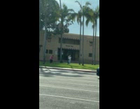 Two women tiktok dance outside Recital Hall