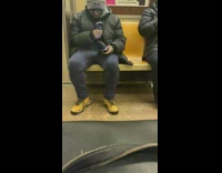 Guy uses magnifying glass on phone