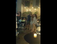 Guy three girls restaurant patio candles flash