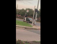 Man black jacket white pants stand on bench sidewalk