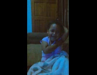 Little girl tickles herself on her armpit and laugh