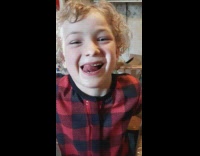 Young boy pick nose with his tongue