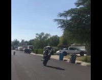 Motorcyclist does wheelie on neighborhood street 