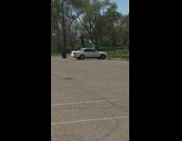 Guy stands on top of white car 