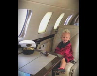 Boy is Hugh Hefner for halloween in private jet, woman in bunny costume poses with him