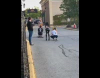 Woman in a blue bikini poses at the parking lot