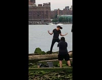 Man spread arms screams for music video shoot river