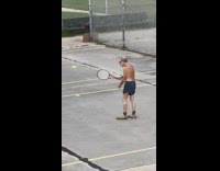 Old man no shirt blue shorts plays tennis game without trying