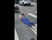 Woman in blue outfit lie down on the pedestrian lane