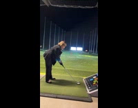 Woman at driving range loses balance and falls forward