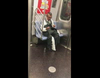 Man cleans his shaving razor on the subway train 