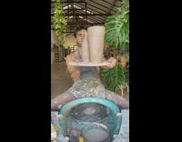 Guy admires his clay pottery work after finishing 