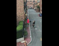 Red dress girl planter black lamppost sidewalk 