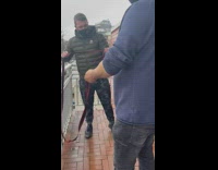 Two guys on balcony lower couch ground 