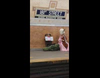 Woman in tall wig plays cello 