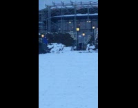 Woman gray sweater ice skate spin snow