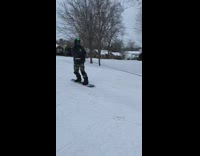 Man snowboard pulled car truck snow street