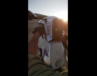 Guy rides his motorcycle and does a wheelie stunt