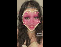 Lady with Cake Make Up Blows Candle