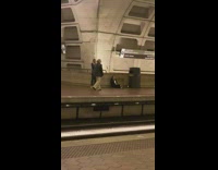 Woman black coat walk pose train station