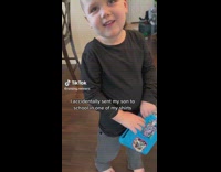 Little boy wearing moms long black shirts