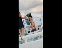 Woman sits on pool chair blue pillow and takes picture