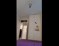 Guy wearing bandana and cape jumps onto bed 