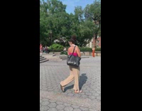 Guy rides toy car around park 