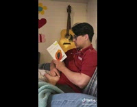Boyfriend reads book for girlfriend 
