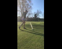 girl shotgunning beer while playing golf
