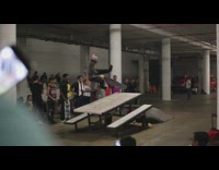 Collab ShredSlams - Skater jumps onto white bench table, falls off skateboard and lands hard on his back