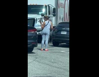 Woman photograph grey leggings butt car reflection