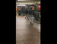 Guy yells out loud in subway station and hits payphone without paying