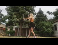 Black skirt girl dances white hula hoop 