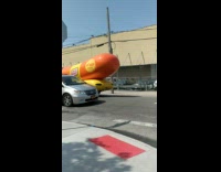 Oscar Mayer weiner hot dog car drives on the street