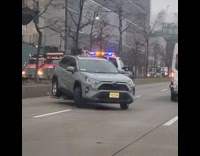 NYPD tow truck with car halfway off 