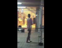 Guy works out arms in clown mask in front of HM 