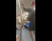 Guy on subway train hands upside down and then starts twerking