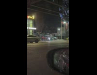 Red and black car drives with rainbow LED