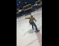Guy yellow plaid shirt tackles hockey rink window, then trips and falls on ice